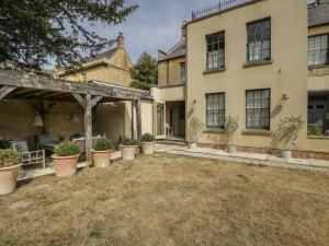 an exterior view of a house with potted plants at Cotswold House in Moreton in Marsh