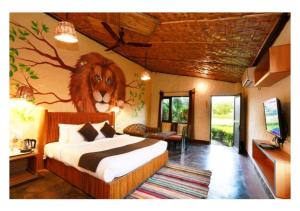 a bedroom with a bed with a lion on the wall at Corbett Soho Resort in Haldwāni +180 photos