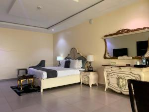 a bedroom with a bed and a large mirror at Corporate Residence in Port Harcourt