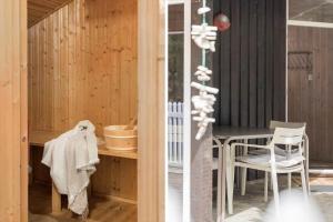 a dining room with a table and chairs in a house at 0011-Romo-Trinnesvej-9 in Høm +16 photos