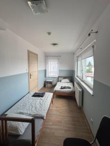 a room with two beds and a window at Villa AGNAT in Gdańsk