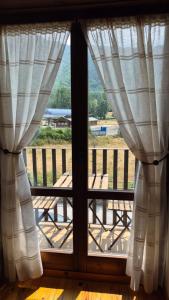 an open window with a view of a deck at Apartamentos Nogueret in Benasque