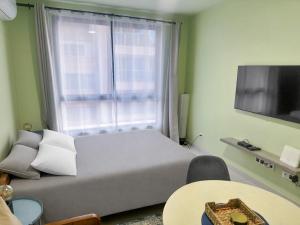 a bedroom with a bed and a large window at AP2B Praia in Praia