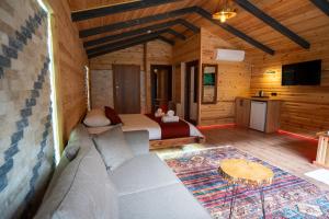 a bedroom with a bed and a couch in a room at Gale Suit in Çamlıhemşin