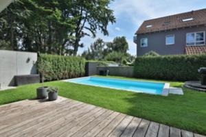 a backyard with a swimming pool in the grass at Studio-Wohnung Lichtblick in Gersthofen