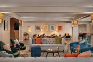 a living room with a couch and chairs at Hotel Indigo - Winston-Salem Downtown by IHG in Winston-Salem