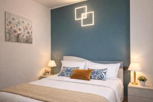 a bedroom with a bed with a blue wall at Villa Lake Luxury in Colico +33 photos