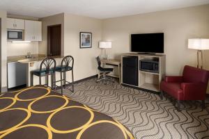 a hotel room with a bed a desk and a tv at Super 8 by Wyndham Mars/Cranberry/Pittsburgh Area in Cranberry Township