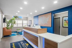 an office with a blue wall and a reception desk at Microtel Inn Georgetown - Lexington North in Georgetown