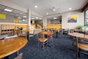 a dining room with wooden tables and chairs at Days Inn by Wyndham Norfolk Airport in Norfolk