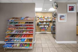 a store aisle with a rack of toothbrushes at Days Inn by Wyndham Norfolk Airport in Norfolk