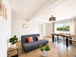 a living room with a couch and a table at Le logis de Louze in Saint-Maurice-lʼExil