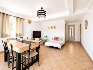 a living room with a table and a couch at Le logis de Louze in Saint-Maurice-lʼExil