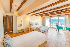 a hotel room with two beds and a balcony at Casa Mare Bodrum in Bodrum City +31 photos