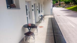 a row of tables and chairs on the side of a building at Prenočišča Dany in Dravograd