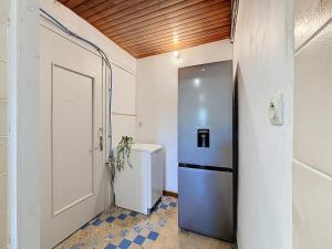 a small bathroom with a refrigerator and a toilet at Le logis de Louze in Saint-Maurice-lʼExil +13 photos