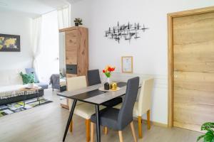 a dining room with a black table and chairs at Prenočišča Dany in Dravograd +10 photos