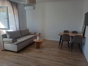 a living room with a couch and a table at Apartmani KIKO in Međugorje