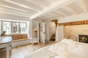 a bedroom with a white bed and a fireplace at 5 Bed in Bishops Lydeard oc-b45427 in  Liscombe