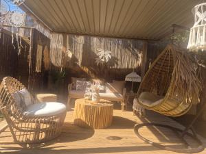 a patio with chairs and a hammock and a table at Grand Villa Nefeli - Private Spa in Lagonissi