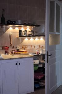 a kitchen with white cabinets and a counter top at شمس in Hammamet Nord +10 photos