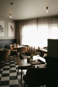 a restaurant with tables and chairs and a window at Aurora Farm Hotel in Laugar