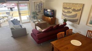 a living room with a couch and a table at Ahoy Brunswick 1 in Brunswick Heads