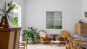 a living room with chairs and a table at Bruns Beach Shack in Brunswick Heads
