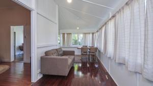a living room with a couch and a table at Pinchin's Place in Brunswick Heads +7 photos