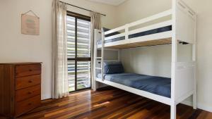 a bedroom with two bunk beds and a window at L'Aqua by Lifestyle. in New Brighton +7 photos