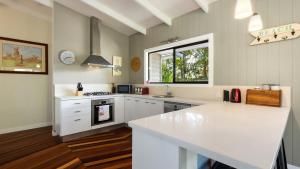 a kitchen with white cabinets and a white counter top at L'Aqua by Lifestyle. in New Brighton