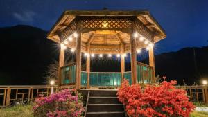 a wooden gazebo with stairs and lights at Gapyeong Swimteo Pet Pension in Gapyeong +3 photos