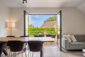 a dining room with a table and chairs at Hoeve de Eik in Epen