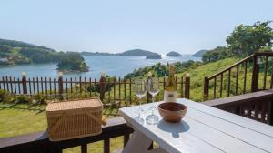 a table with two glasses and a bottle of wine at Yeosu Greenhouse Pension in Yeosu