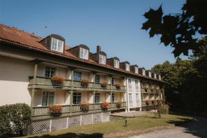 a building with flower boxes on the balconies of it at Hotel Bayerischer Hof Miesbach, BW Premier Collection in Miesbach