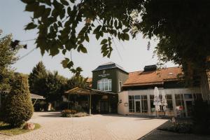 a building with a building with a roof at Hotel Bayerischer Hof Miesbach, BW Premier Collection in Miesbach