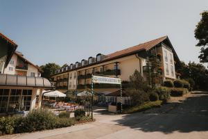 a building with a market in front of it at Hotel Bayerischer Hof Miesbach, BW Premier Collection in Miesbach