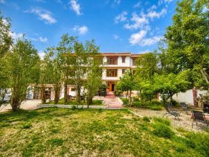 an exterior view of a building with a yard at Zotpa Hostel in Leh