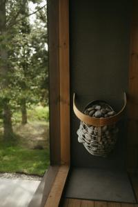 a basket of rocks sitting on a window sill at Aurora Farm Hotel in Laugar +67 photos