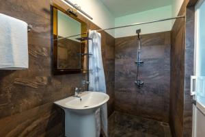 a bathroom with a sink and a shower at Fisherman's Cove in Wattala