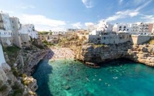 an aerial view of a town with blue water and buildings at Archè Luxury private Spa in Polignano a Mare
