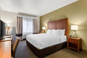 a hotel room with a large bed and a television at Comfort Inn & Suites Midtown in Ruidoso +42 photos
