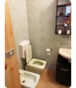 a bathroom with a white toilet and a sink at Appartamento Sestriere in Sestriere