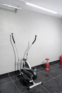 a room with a exercise bike and a red stool at The Seamless Oasis in Cape Town