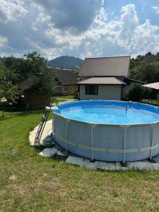 a large swimming pool in the yard of a house at Grey House in Slavske