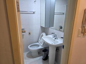 a small bathroom with a toilet and a sink at Incheon Airport Yeongjong Guesthouse in Incheon