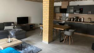 a kitchen and living room with a couch and a table at Ferienwohnung Für 4 Personen 90 M² in Naumburg