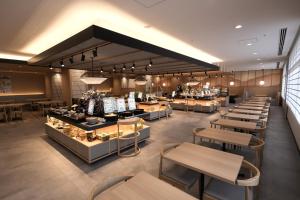 a restaurant with tables and chairs and a bakery at Almont Hotel Kyoto in Kyoto