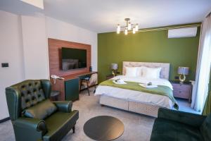 a bedroom with a bed and a desk and a chair at Aurelius Hotel & Restaurant in Pljevlja