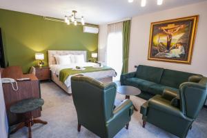 a hotel room with a bed and a couch at Aurelius Hotel & Restaurant in Pljevlja